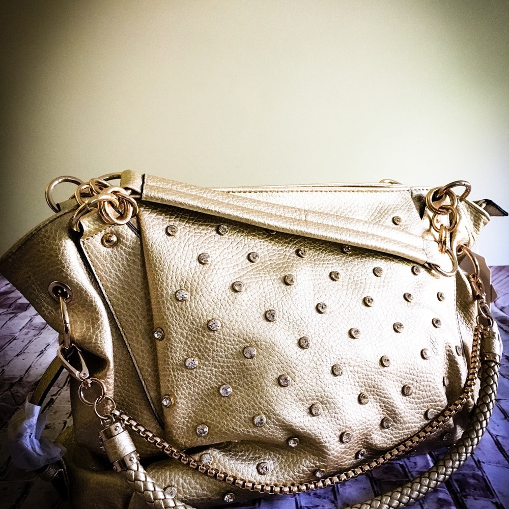 New faux leather handbag gold color studs, gold tone hardware, zip top.